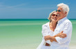 © Darren Baker - Happy Senior Couple Laughing Embracing on a Tropical Beach