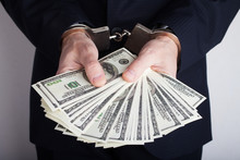 Businessman In Handcuffs Holding Bribe, Closeup