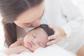 Wall Mural - happy mother with baby in bed