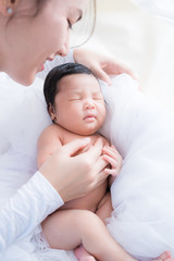 Wall Mural - happy mother with baby in bed