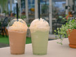 Green tea frappe and coffee frappuccino on white table