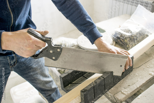Fotografie, Obraz saws with a knife at the corner with the device, wood hacksaw