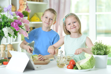 Wall Mural - Cute little brother and sister cooking