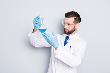 portrait of concentrated busy scientist with stubble in white lab coat, gloves examine, looking at f