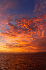 summer sunset colorful sky with dramatic purple red and yellow clouds over picturesque water landsca
