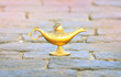 Beautiful Aladdin lamp on stones. Oriental fairy tale concept of fulfillment of desires with the help of a miracle.