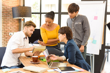 Wall Mural - Smart handsome european man business officer explaining internal meeting to his project team in modern office. They are the multi ethnic business person group in casual suit.