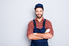 Portrait Of Handsome Mechanic With Stubble In Blue Overall, Shirt Having His Arms Crossed, Looking At Camera, Isolated On Grey Background