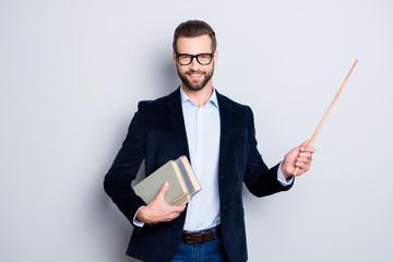 portrait of cheerful teacher with stubble in shirt jacket, having books in hand and showing with poi