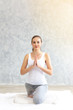 © thbangkok - Young caucasian very attractive woman practicing yoga, sitting in Padmasana doing yoga exercise or Lotus pose or namaste pose. Working out on her bed.