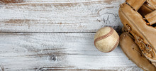 Flat Lay View Of Old Baseball And Mitt On White Rustic Wooden Boards