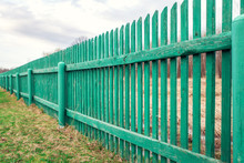 Rustic Green  Wooden Fence In Countryside