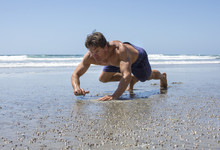 Man Doing Beach Bear Crawl Workout