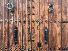 Close Up Of An Ancient Wooden Door With Wrought Iron Decorations, Alicante Spain
