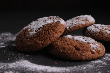 Wall Mural - oatmeal cookies on a black table in castor sugar