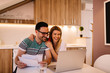 © Nebojsa - Young couple calculating their domestic budget together in living room.