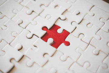 White puzzle with one bright red piece, business and connection concept