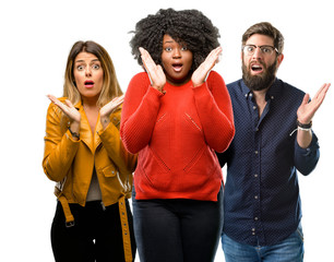 Poster - Group of three young men and women happy and surprised cheering expressing wow gesture