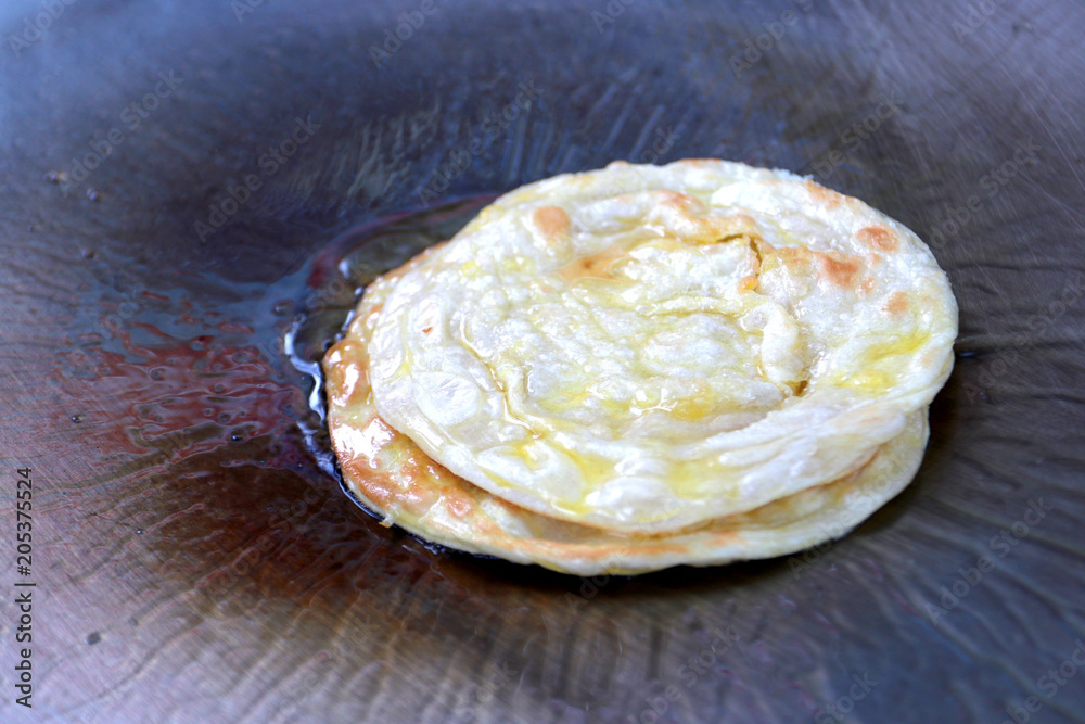 making eggs roti roll on hot metal pans with boiled vegetable oil ...