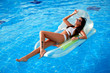 © Валентина Назарова - Beautiful girl in a white swimsuit sunbathing by the pool.
