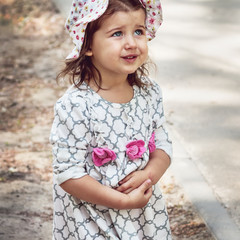 a little dissatisfied girl holding her stomach