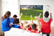 © Syda Productions - sport, leisure and entertainment concept - friends or football fans watching soccer on projector screen at home, one team wins another loses