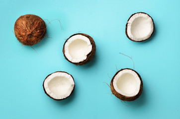 Wall Mural - pattern with ripe coconuts on blue background. top view. copy space. pop art design, creative summer