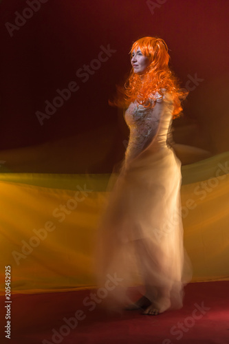 Old Female Actress With Orange Hair Dancing In White Dress With