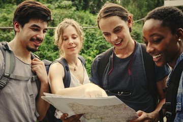 Wall Mural - Friends checking where to go on a map