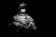 © Getmilitaryphotos - United States Armed Forces soldier in battledress with black glasses and mask on face, armed squad automatic weapon emerges from darkness. Military threat, secret stealth mission, hybrid war combatant