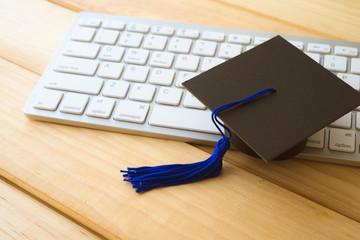 Graducate cap on keyboard with mouse, E-learning online education concept