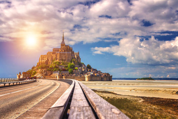 Beautiful panoramic view of famous Le Mont Saint-Michel tidal island with blue sky. Normandy, northern France