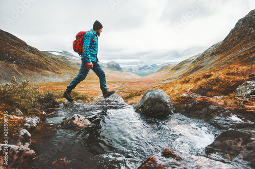 Cuadros en Lienzo Man solo traveling backpacker hiking in scandinavian mountains active healthy li