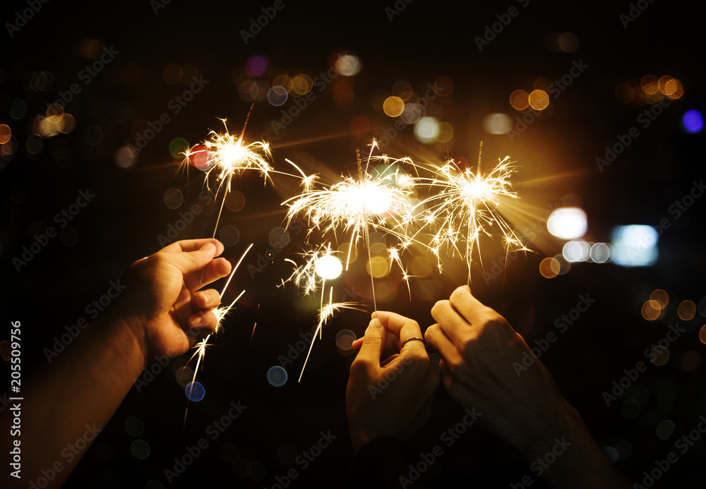 Celebrating with sparklers in the night - obrazy, fototapety, plakaty 