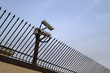 Security surveillance camera on the fence.