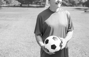 Wall Mural - Mature man holding a football