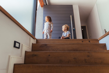 Wall Mural - Kids on stairway looking outside