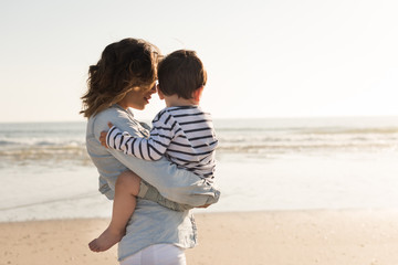 Wall Mural - mother at the beach with her baby