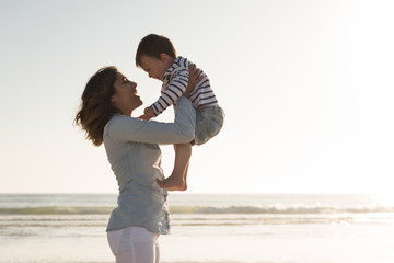 Wall Mural - mother at the beach with her baby