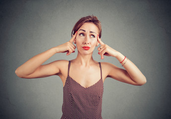 Wall Mural - woman tries to gather with thoughts, thinking about something, looking with doubt up