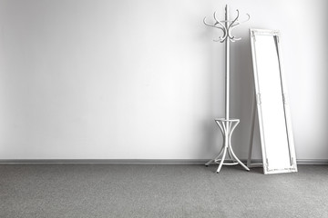 Wall Mural - bright home interior with white coat rack and mirror on gray floor and copy space for your decoratio