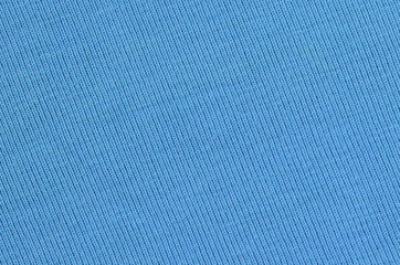 The texture of the fabric in blue color. Material for making shirts and blouses