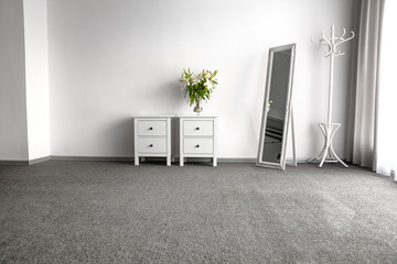 Wall Mural - bright home interior with white cupboards and coat rack andflowers. gray floor and free copy space f