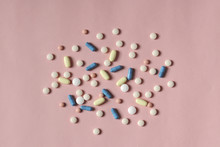 Overhead View Of Medicines Over Coral Background