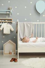 Wall Mural - Adorable baby in the white outfit in the nursery