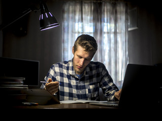 portrait of young man working in the dark room at home