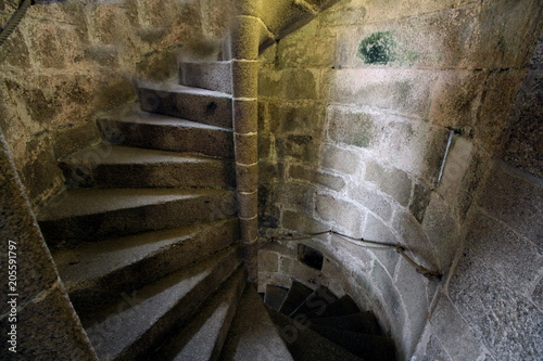 Fotomural Old stone spiral staircase going up the inside of a castle tower.