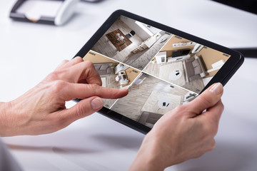 Aufkleber - Person Monitoring CCTV Footage On Digital Tablet