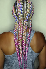 Wall Mural - thick boxer braids, blonde braided with pink kanekalon, very beautiful and creative youth hairstyle in gentle colors on a white background, French braids on the girl's head close-up