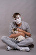© Ranta Images - Young handsome man wearing white mask against gray background
